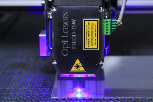 Close-up of a laser head with violet light